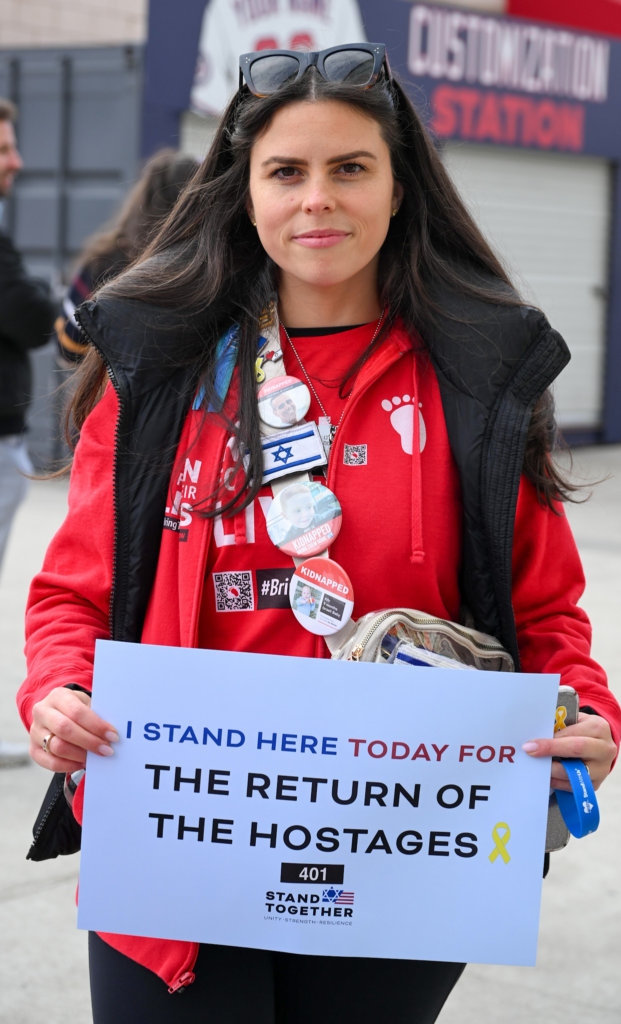 woman hold sign calling for the return of hostages